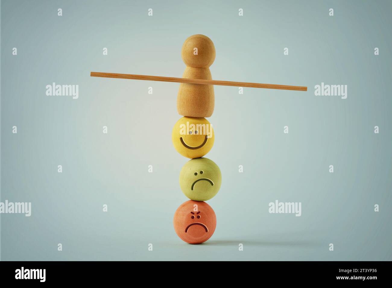 Pion en bois équilibrant sur des visages de perles avec différentes expressions d'humeur - concept d'équilibre émotionnel et mental Banque D'Images