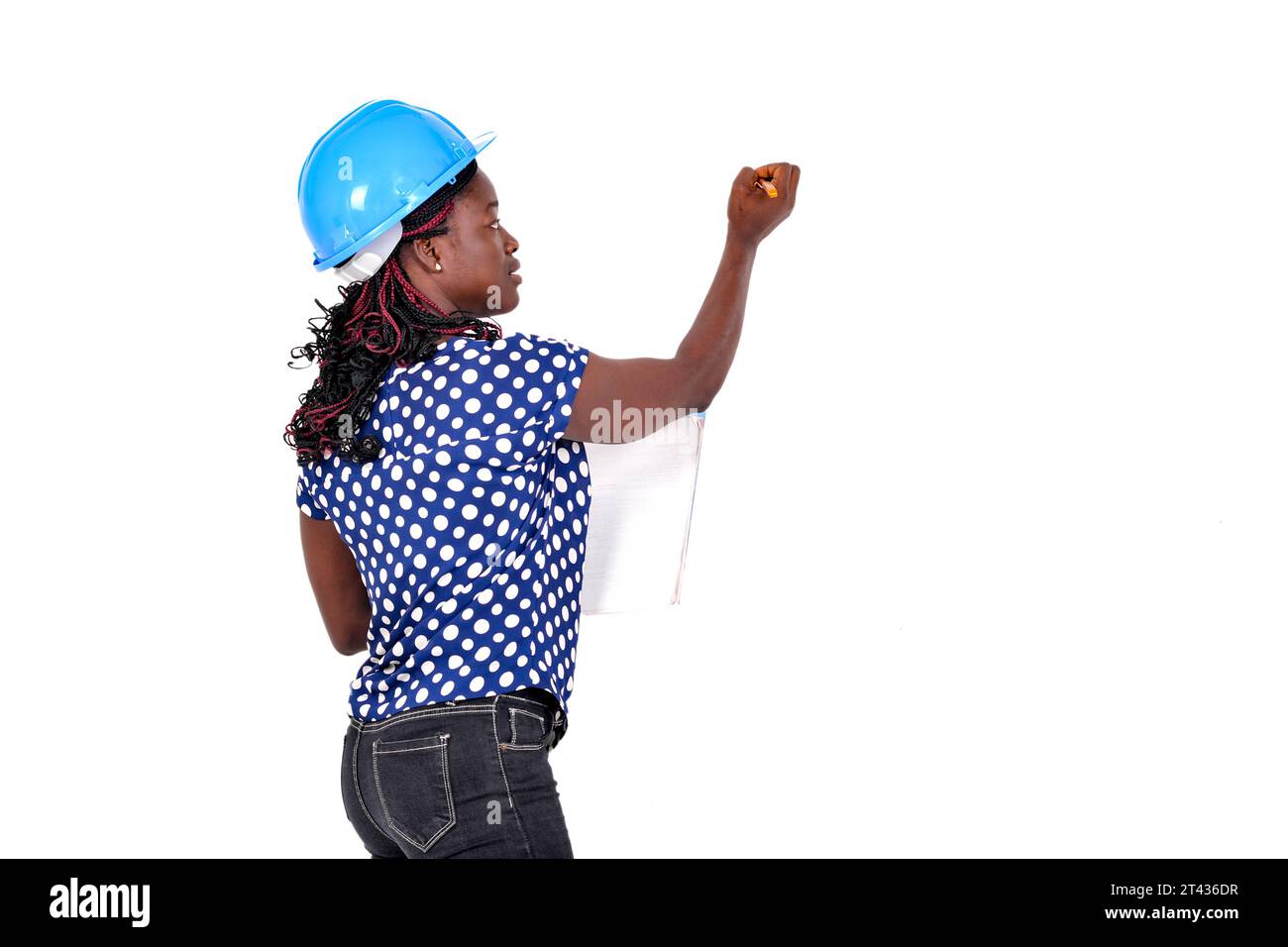 jeune femme ingénieur en construction portant un casque de sécurité bleu et écrivant sur un tableau blanc avec un marqueur. Banque D'Images