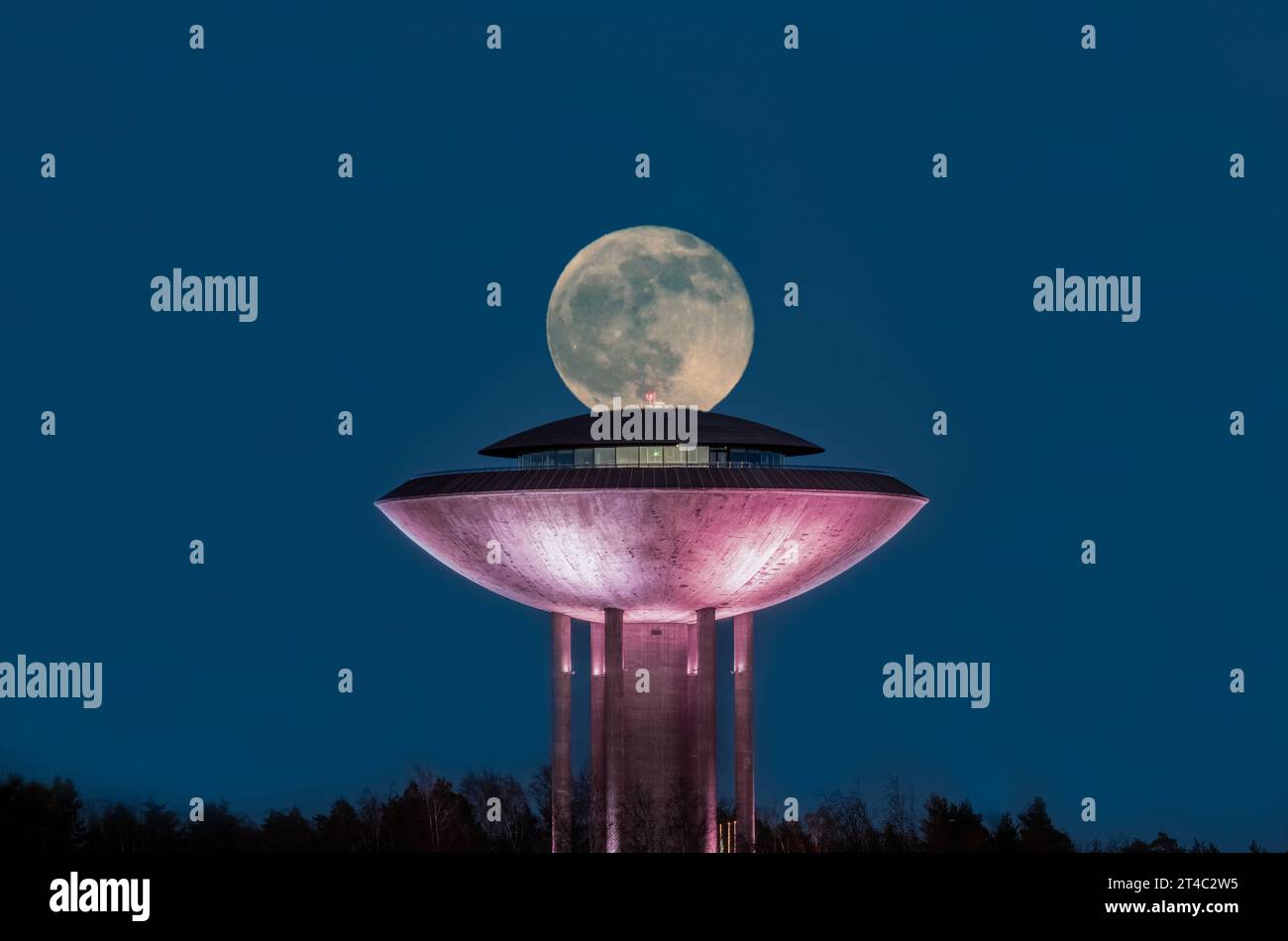 Énorme pleine lune dans le ciel nocturne au-dessus d'un bâtiment de restaurant à Espoo Banque D'Images