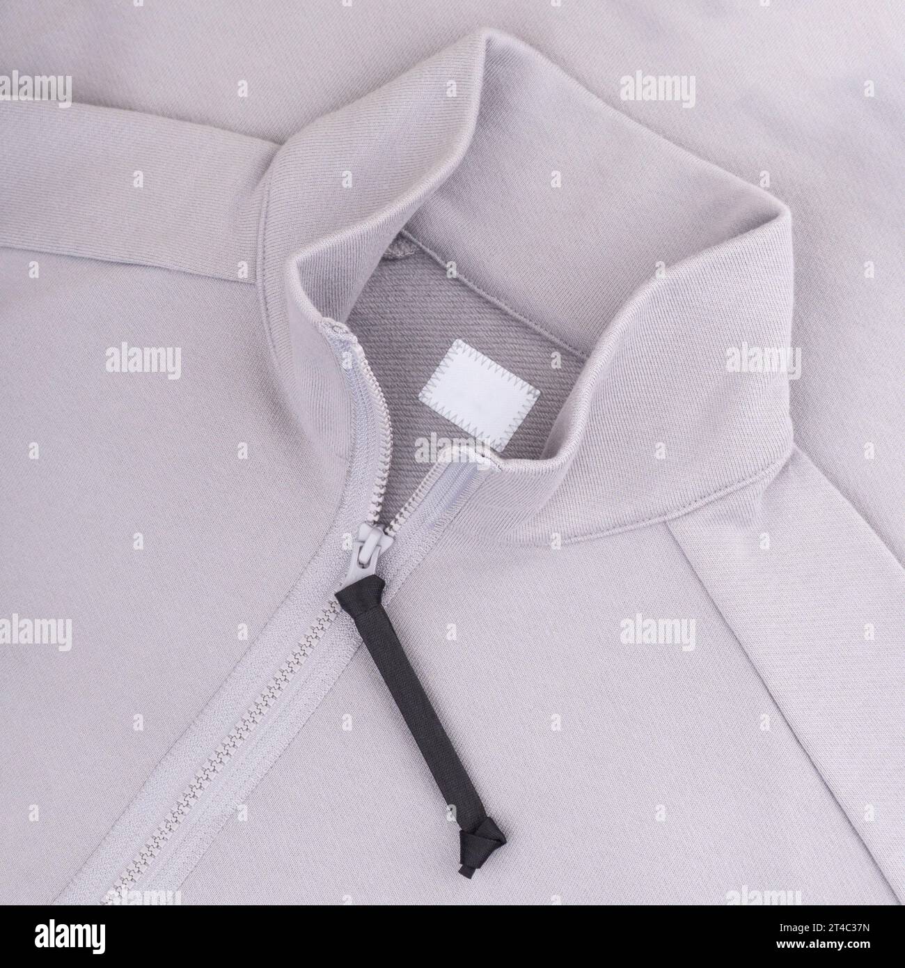 Col d'un pull gris clair avec une maquette d'étiquette de vêtement à fermeture éclair Banque D'Images