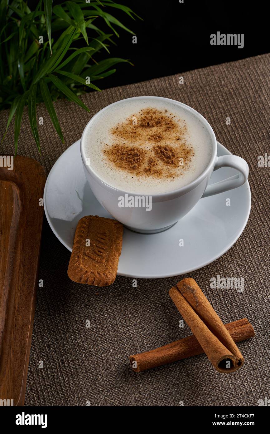 Une tasse de sahlep chaud avec de la cannelle sur un plancher en bois Banque D'Images