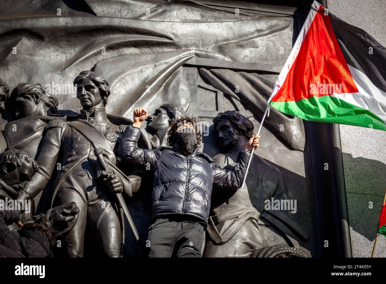 Un manifestant brandit le drapeau de la Palestine lors de la manifestation pro-palestinienne à Trafalgar Square Banque D'Images