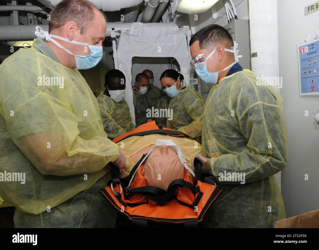 1008197282P-001 SAN DIEGO (19 août 2010) des marins à bord du navire d'assaut amphibie USS Makin Island (LHD 8) transportent un patient simulé infecté par une maladie contagieuse à partir d'une unité d'isolement expérimentale au cours d'une expérience à objectifs limités. L'évolution parrainée par la 3e flotte se concentre sur le développement de nouvelles façons d'isoler et de mettre en quarantaine les marins soupçonnés de contracter une maladie contagieuse. Marine Banque D'Images