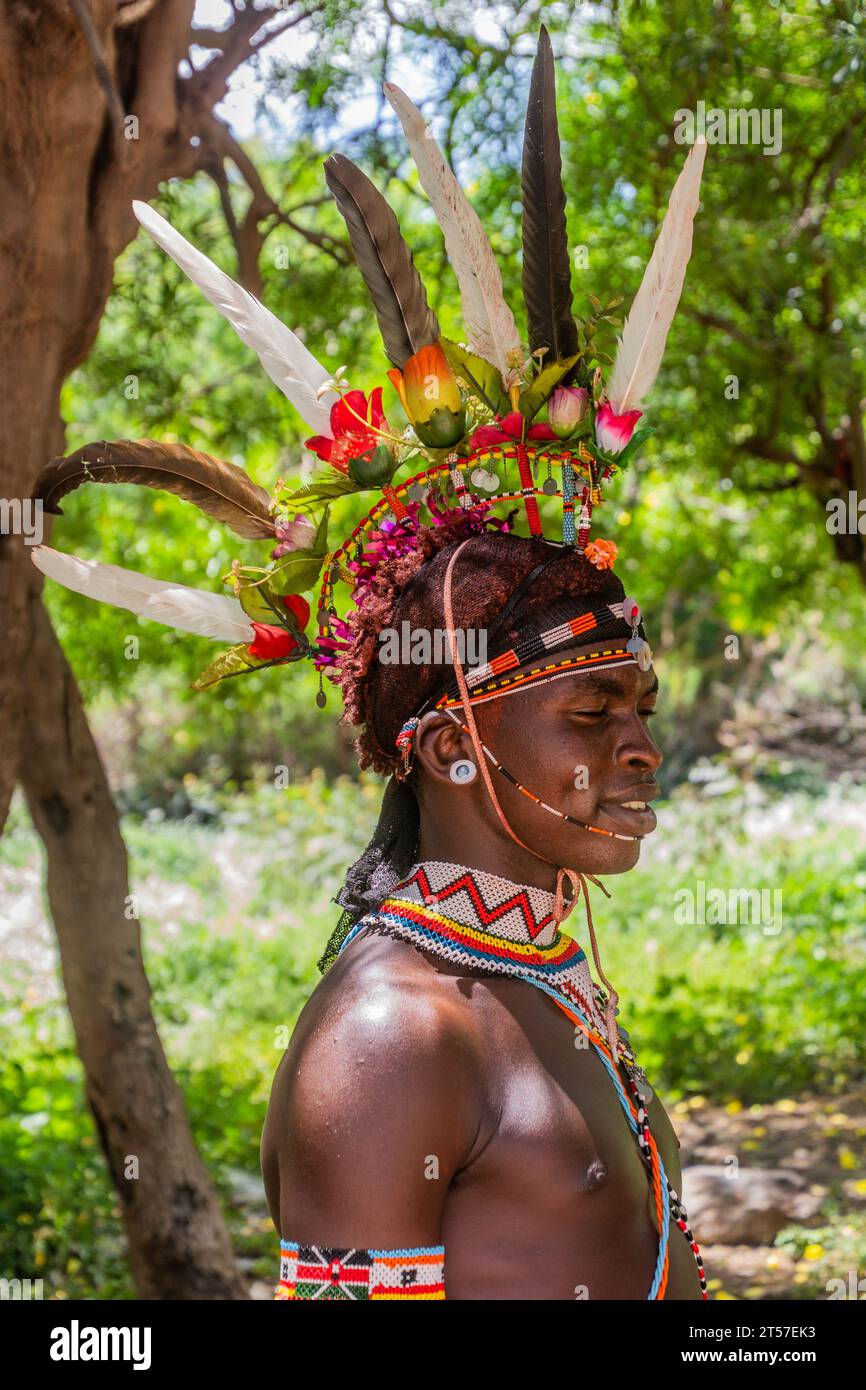 SOUTH HORR, KENYA - 12 FÉVRIER 2020 : jeune homme de la tribu Samburu portant une coiffe colorée faite de plumes d'autruche après sa cérémonie de circoncision. Banque D'Images