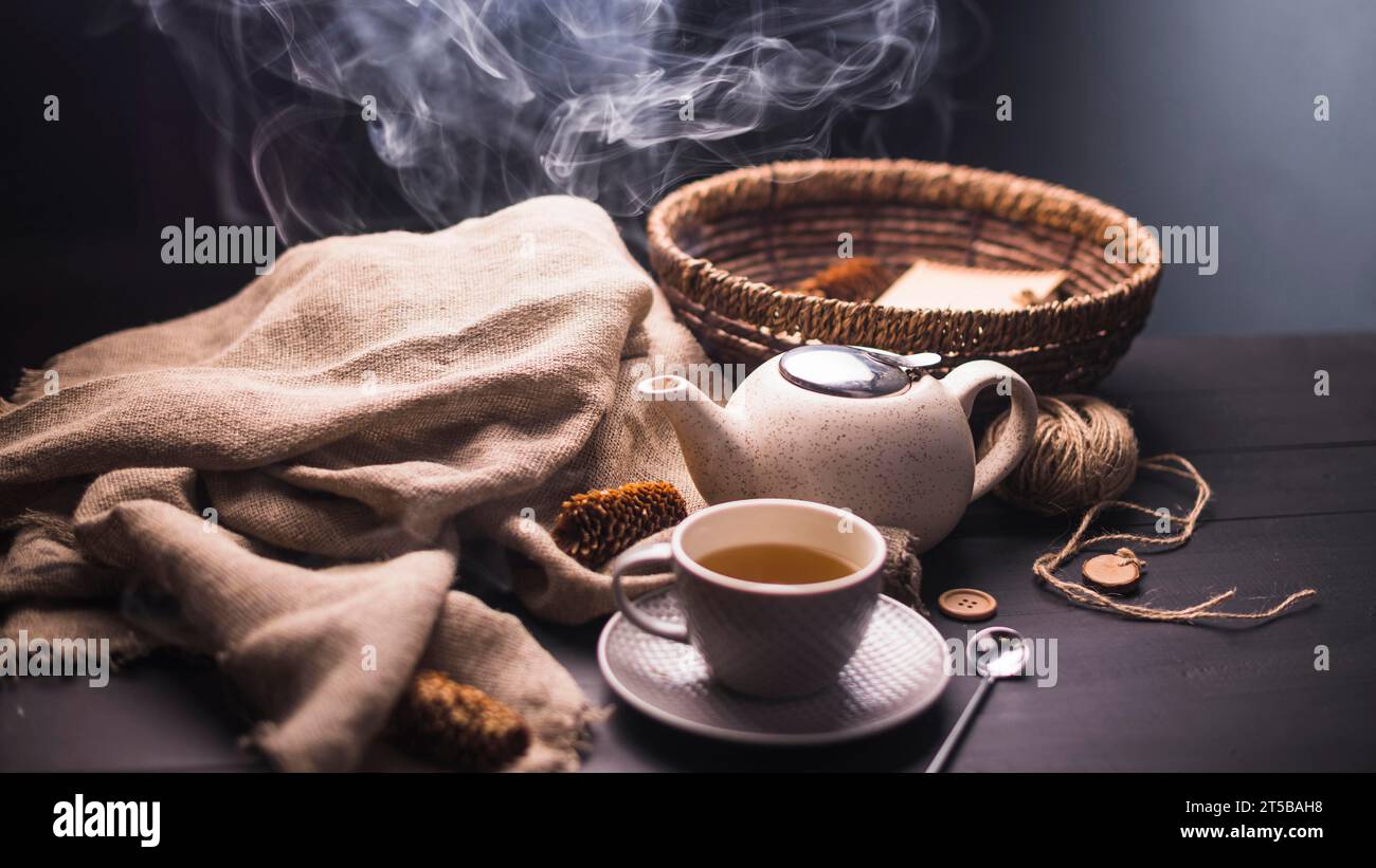 Tisane avec pomme de pin théière sac bouton en osier panier boule table de fil Banque D'Images