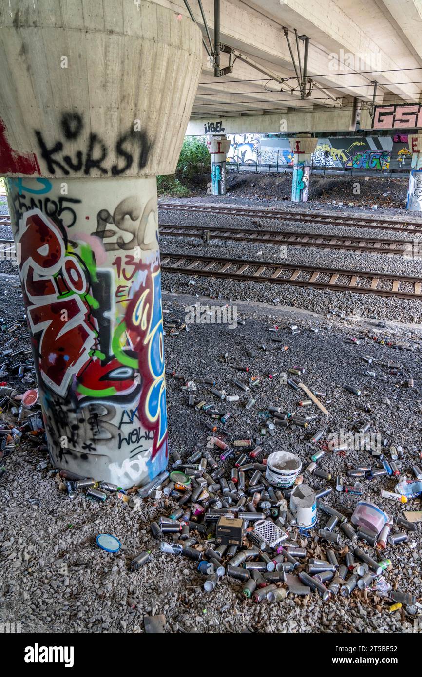 Bombes de peinture en aérosol vides, sur une voie ferrée en dessous d'un pont routier, jetées, éliminées par le pulvérisateur, graffitis, tas d'ordures, Essen, NRW, Allemagne, Banque D'Images