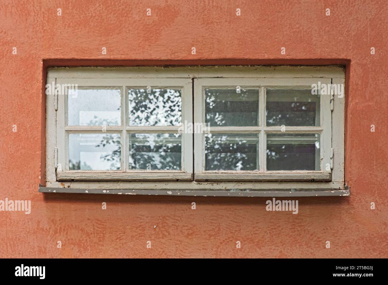 Fenêtre à cadre en bois blanc sur un mur plâtré. Banque D'Images