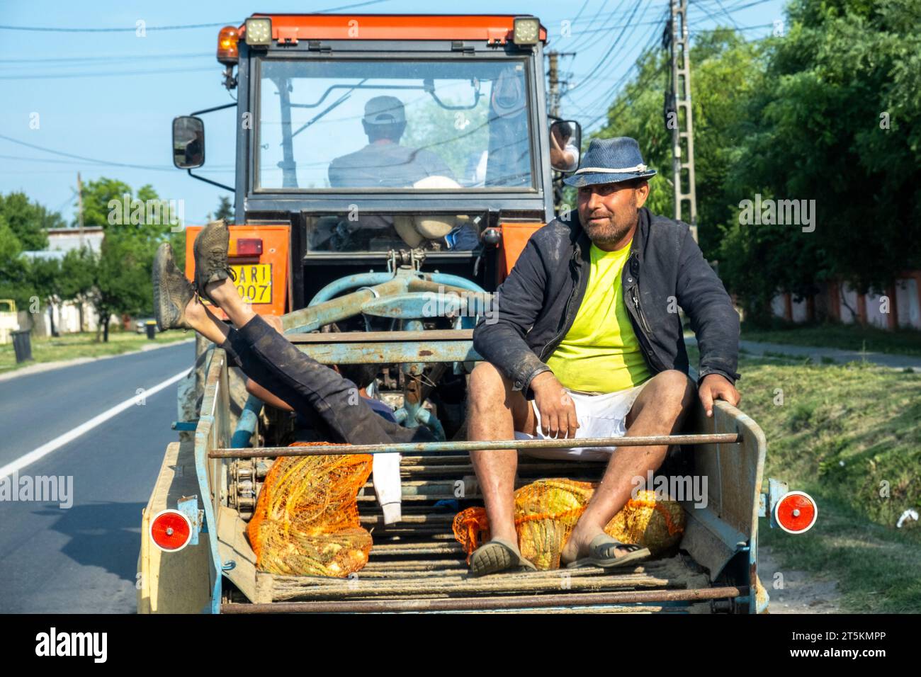 Villageois voyageant pour travailler sur un tracteur à Ghergani, Dambovita, Roumanie. Banque D'Images