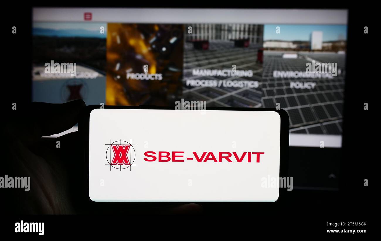Personne détenant un smartphone avec le logo de la société italienne de fixation mécanique SBE-VARVIT S.p.A. devant le site web. Concentrez-vous sur l'affichage du téléphone. Banque D'Images