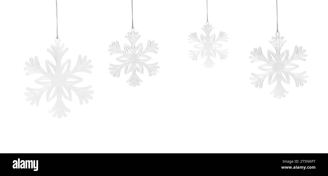 Flocons de neige suspendus isolés sur fond blanc. Joyeux Noël et décorations du nouvel an Banque D'Images