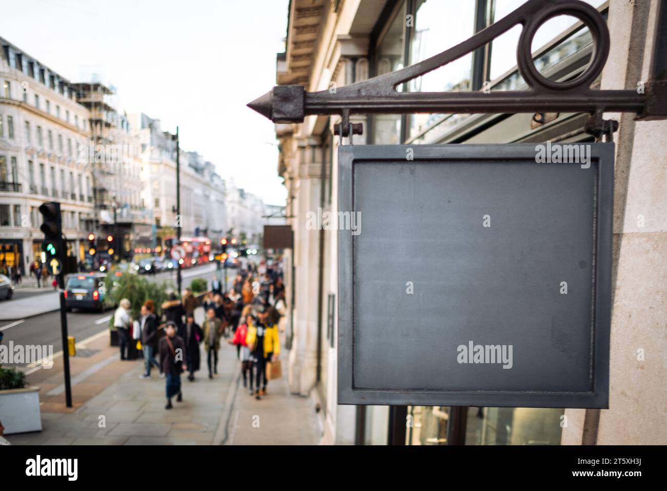 Panneau vierge avec espace de copie et personnes anonymes défocalisées sur la rue commerçante en arrière-plan Banque D'Images