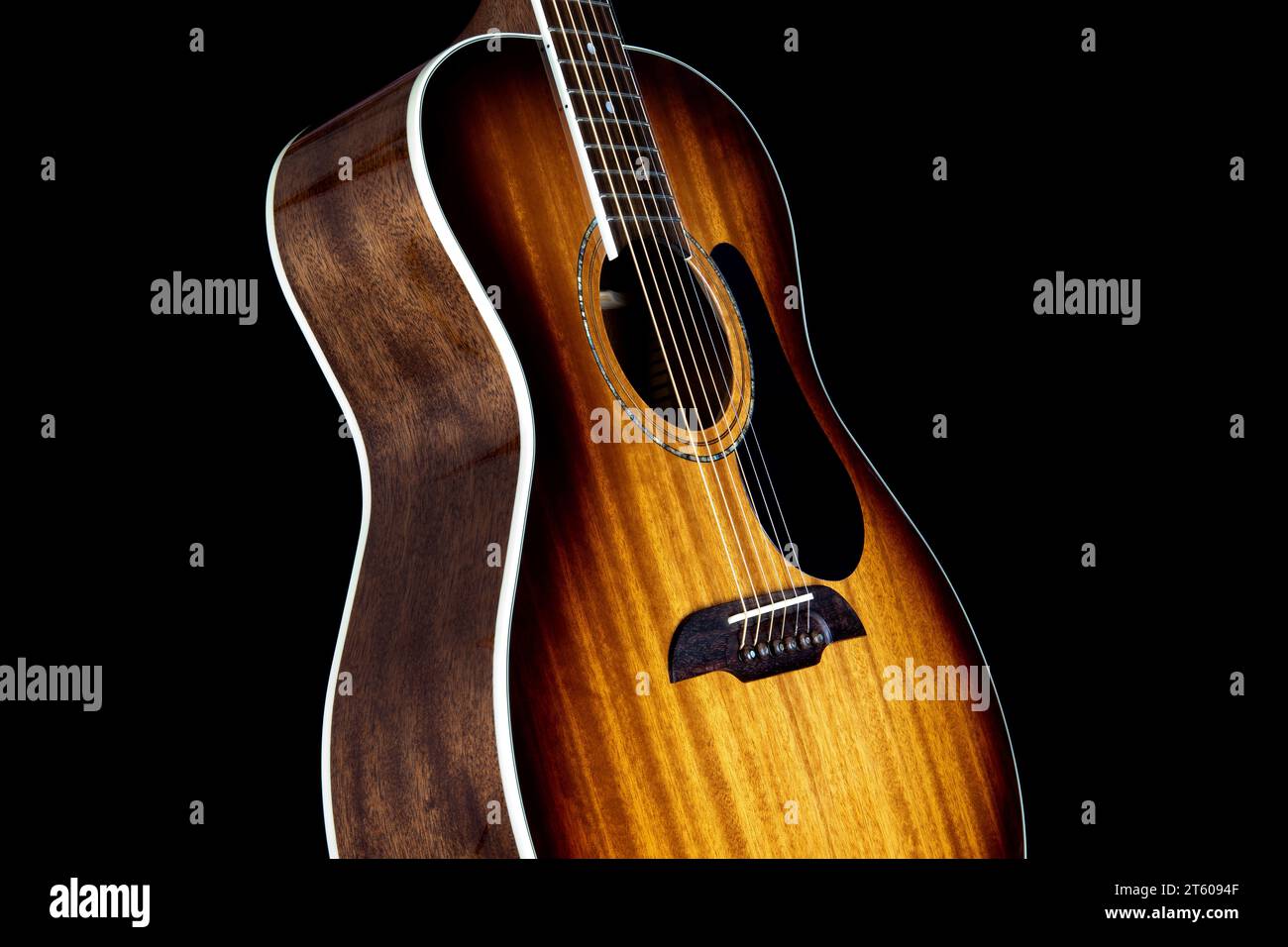 Guitare acoustique acajou isolée verticalement sur un fond noir Banque D'Images