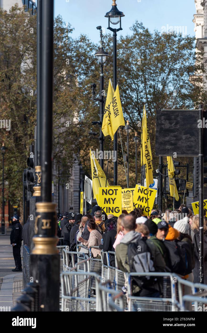 Groupe de manifestants "pas mon roi" à l'extérieur du Parlement avec des banderoles jaune vif alors que le roi Charles arrive pour son discours. 7 novembre 2023 Banque D'Images