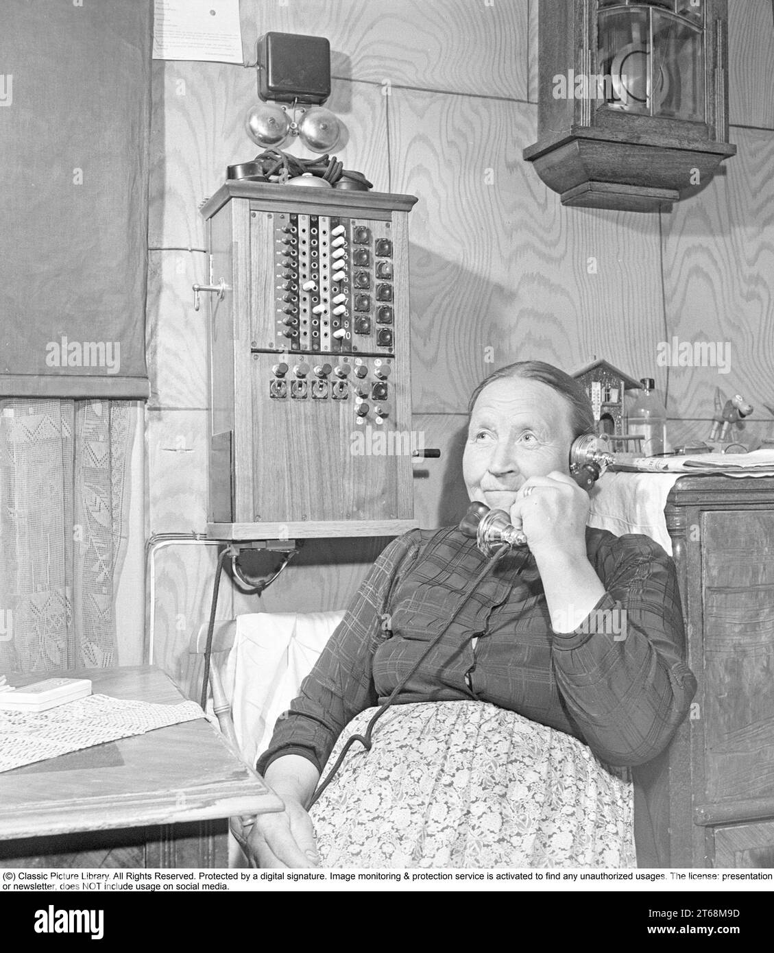 Le village Akkavare en Norrbotten Suède. Abmot Viltok cultive les terres bordant le lac Etnajaure. 'Lac de vie'. Il n'y a pas de route vers le village, vous devez marcher les cinq miles de la communauté la plus proche, Gällivare. Le village n'a pas non plus d'électricité. Abmot a 64 ans et sa femme Hilma a 58 ans. La famille a trois vaches, trois veaux et dix-huit moutons et le seul cheval du village. Photo de Mme Viltok à la maison dans la chambre près du standard téléphonique qui est monté sur le mur. Il était courant dans les villages dans les zones peu peuplées que quelqu'un avait le standard téléphonique à la maison et W Banque D'Images