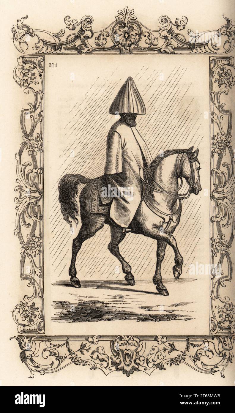 La méthode de l'homme d'un turc pour monter un cheval sous la pluie, 16e siècle. Il porte une sorte de cagoule qui s'ouvre comme un parapluie sur son turban. et un lourd manteau en feutre sur ses vêtements. Maniere dont les Turcs vont a cheval quand il pleut. Dans un cadre décoratif gravé par H. Catenacci et Fellmann. Gravure sur bois de Gerard Seguin et E.F. Huyot d'après une gravure sur bois de Christoph Krieger de Cesare Vecellios costumes anciens et modernes du 16e siècle, Habiti antichi et moderni di tutto il mondo, Firman Didot Ferris fils, Paris, 1859-1860. Banque D'Images