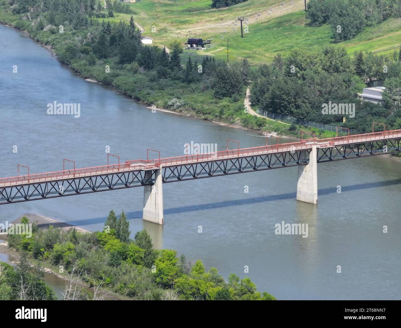 Un magnifique pont enjambant un grand plan d'eau, entouré de terres verdoyantes de chaque côté Banque D'Images