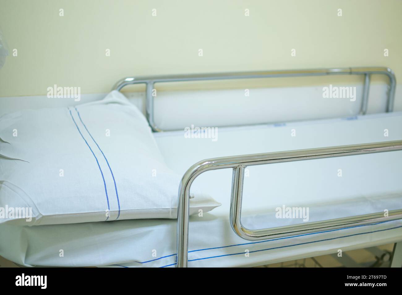 Vue rapprochée du lit d'hôpital avec fond flou du couloir au rez-de-chaussée Banque D'Images