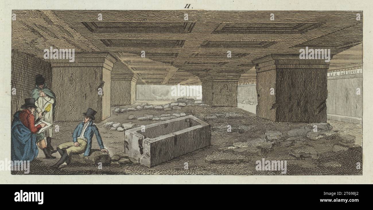 Nécropole de l'ancienne cité étrusque de Tarquinia. Les chambres reposent sur des piliers sculptés dans la roche. Messieurs antiquaires dessinent les catacombes à la lumière des flambeaux. Gravure sur cuivre colorée à la main de Carl Bertuch's Bilderbuch fur Kinder (Livre d'images pour enfants), Weimar, 1810. Une encyclopédie pour enfants en 12 volumes illustrée de près de 1 200 planches gravées sur l'histoire naturelle, la science, le costume, la mythologie, etc., publié de 1790 à 1830. Banque D'Images