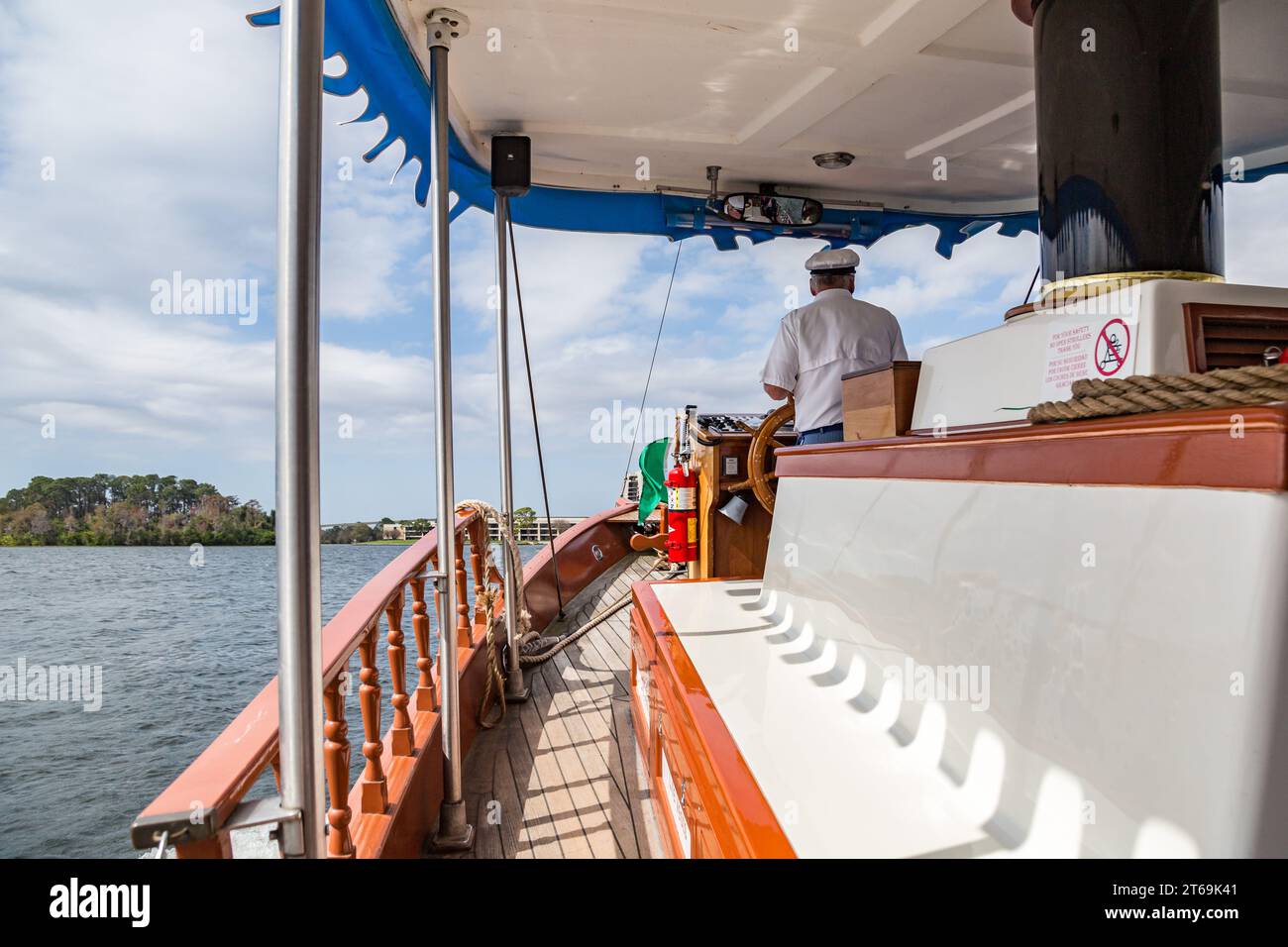 Le capitaine de bateau dirige un bateau touristique à travers Lake Buena Vista vers le Magic Kingdom à Walt Disney World, Orlando, Floride Banque D'Images