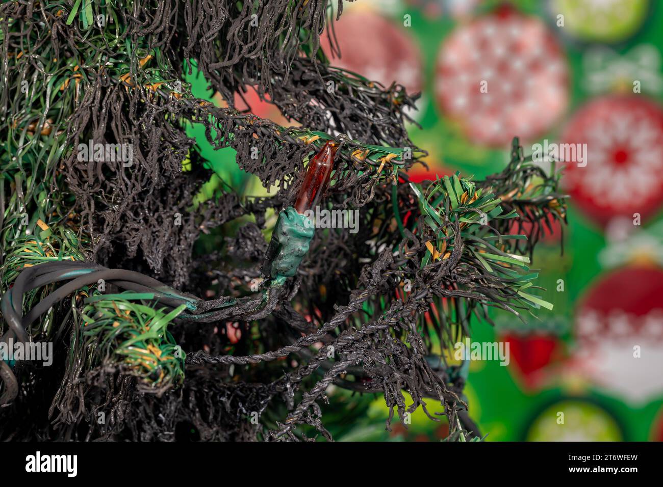 Arbre de Noël artificiel et lumières endommagés par un incendie électrique. Concept d'éclairage de vacances, de sécurité incendie et de prévention des accidents. Banque D'Images