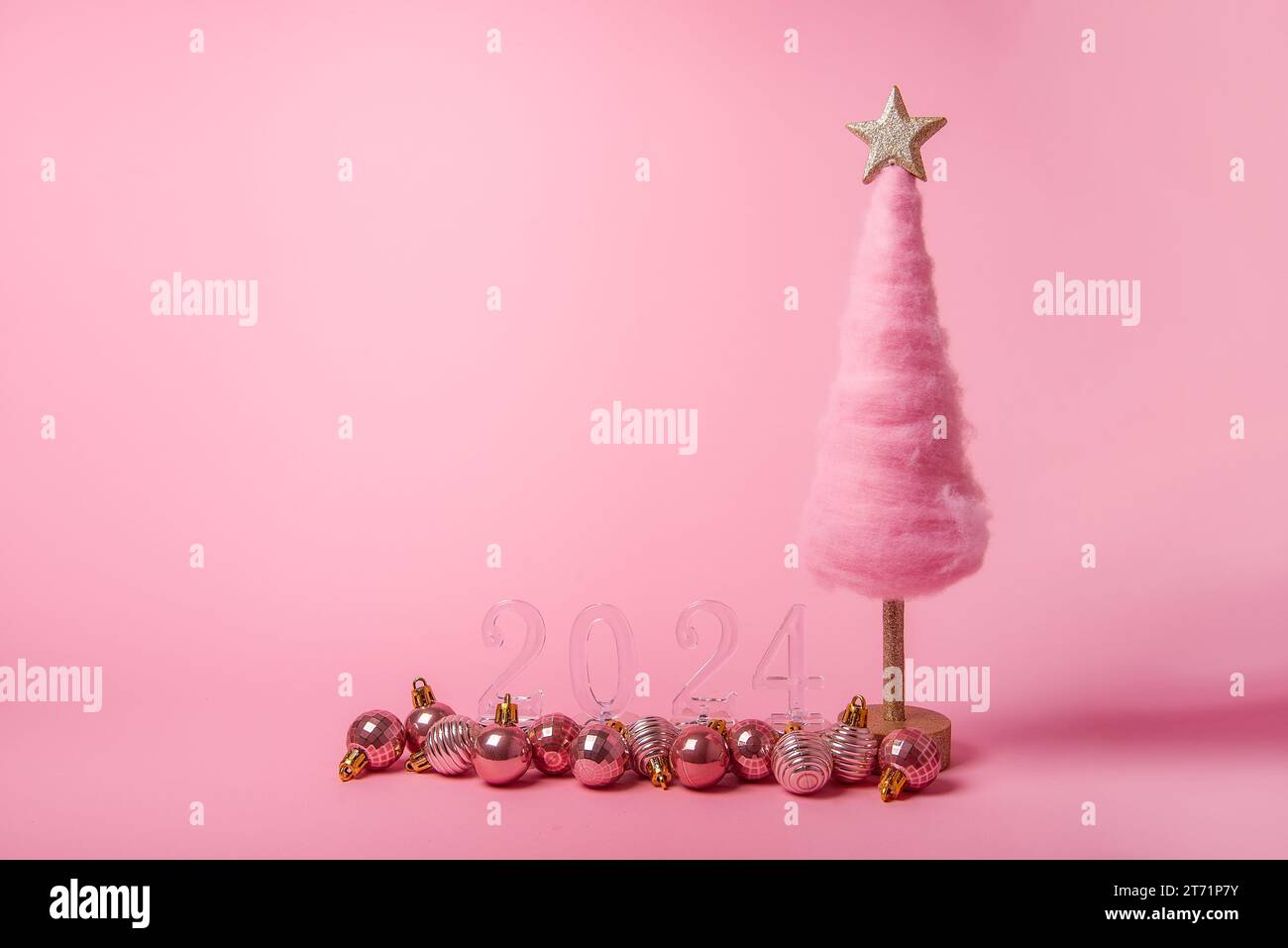 Arbre de Noël créatif pelucheux de fond rose vif isolé en laine, numéros transparents 2024 avec 