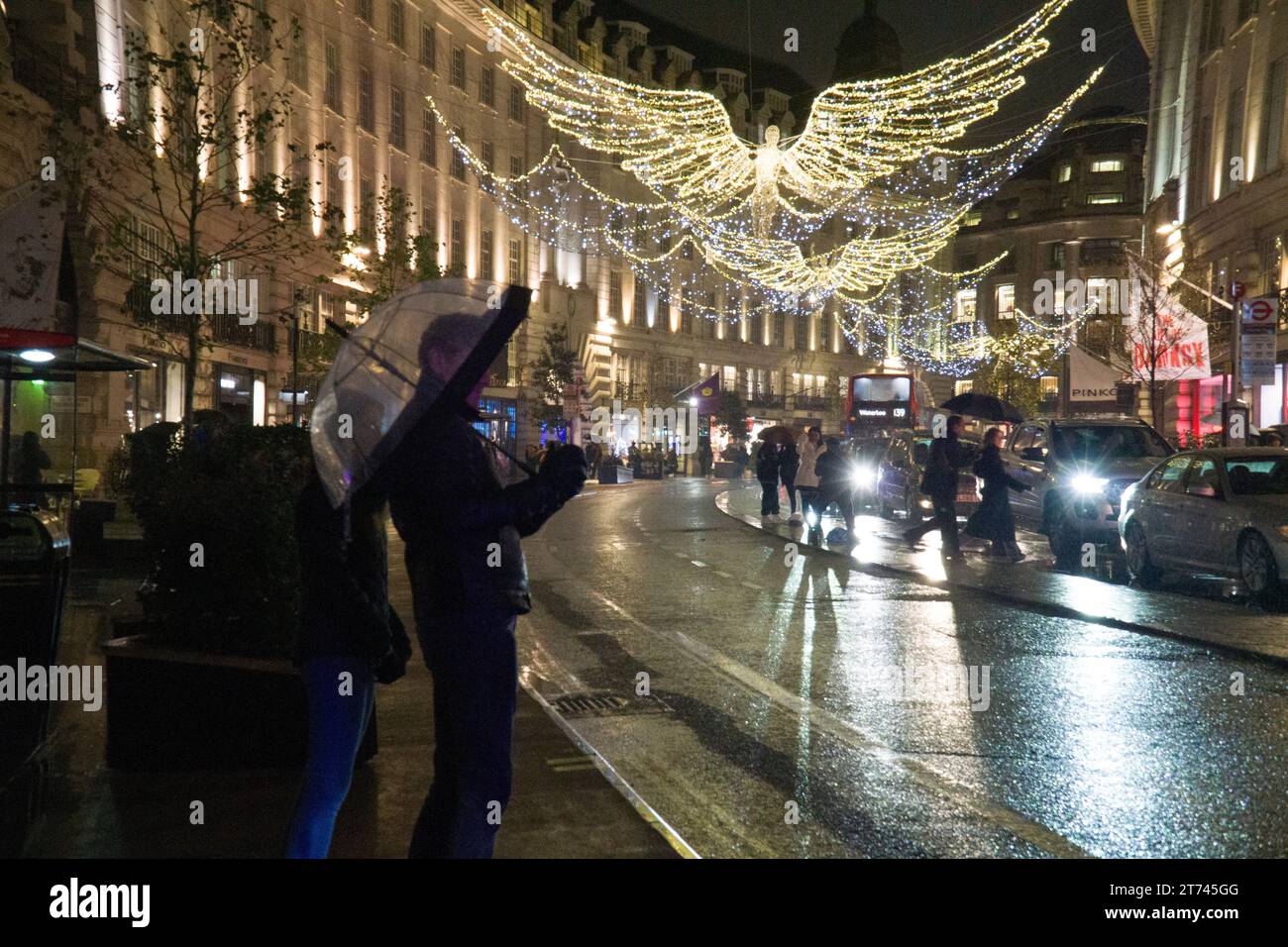 Météo Royaume-Uni, Londres, 12 novembre 2023 : les lumières de Noël sur Regent Street se reflètent sur les routes mouillées par une nuit pluvieuse. Anna Watson/Alamy Live News Banque D'Images