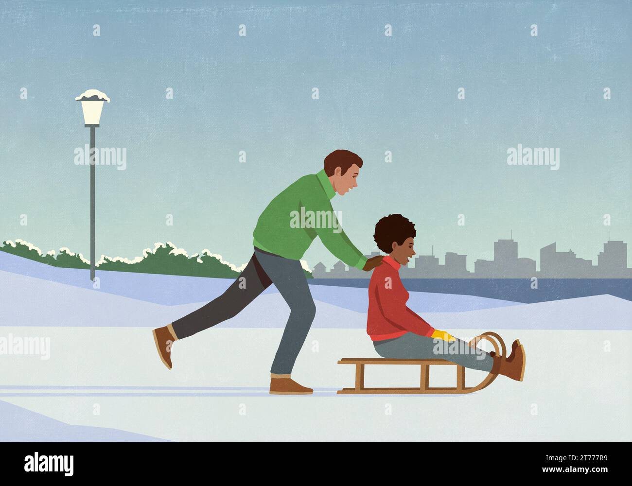 Petit ami poussant petite amie sur le traîneau dans le parc de ville d'hiver enneigé Banque D'Images