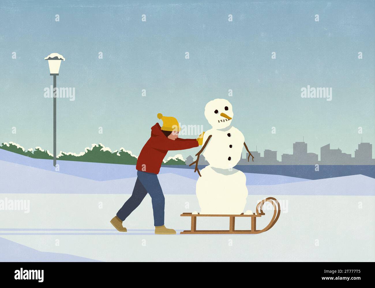Femme poussant le bonhomme de neige sur le traîneau dans le parc enneigé de la ville d'hiver Banque D'Images