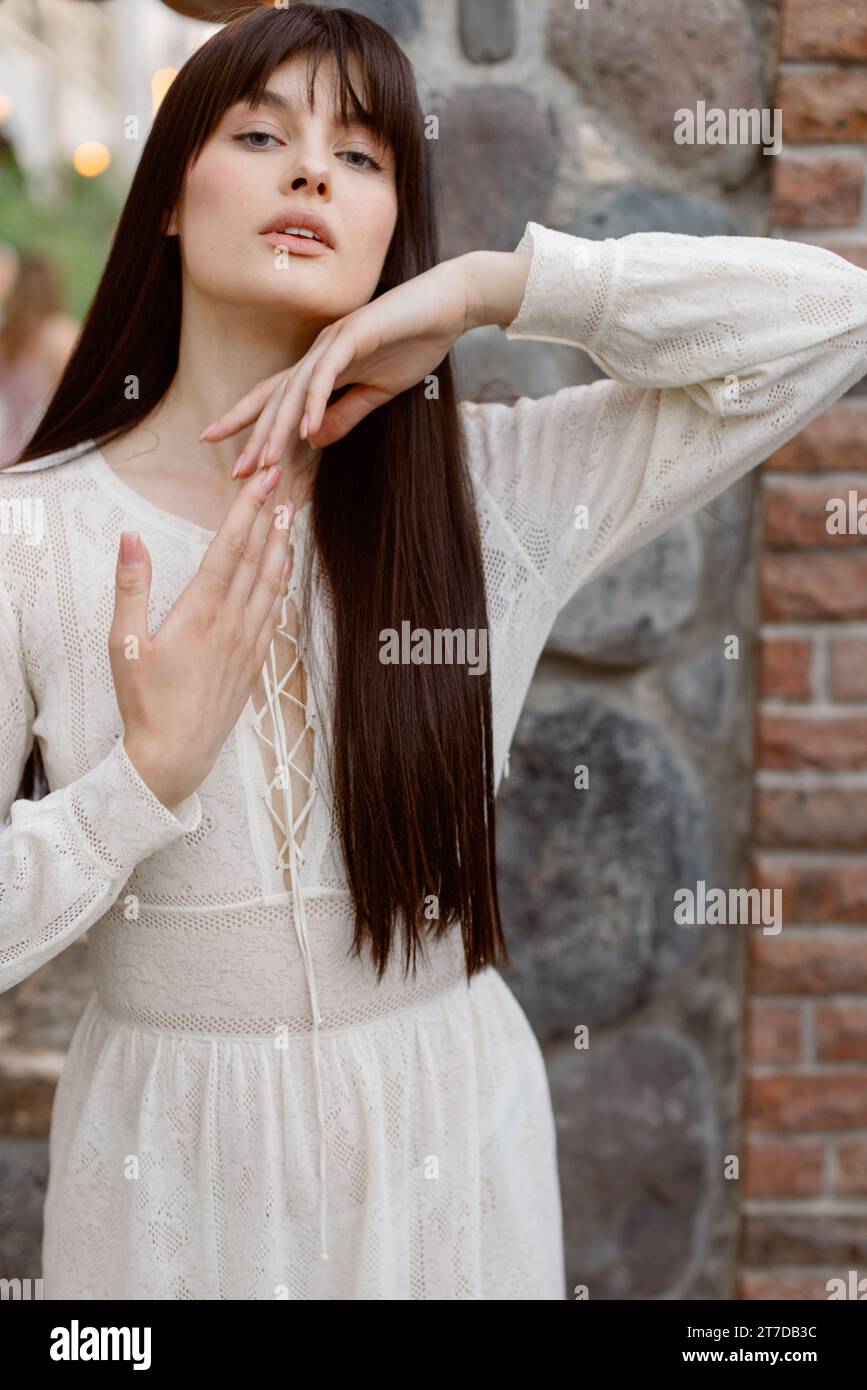 Portrait d'une jolie femme caucasienne portant une longue robe blanche fluide Banque D'Images