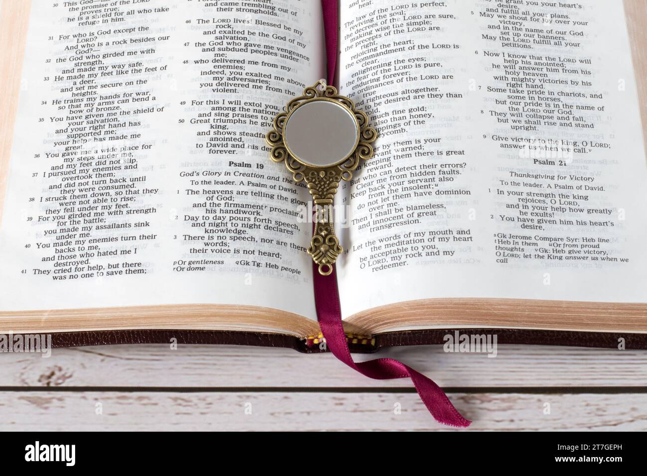 Ouvrez le livre sacré de la bible et miroir antique sur la table en bois. Vue de dessus. Etude des Ecritures, obéissance chrétienne, changement et croissance, concept biblique. Banque D'Images