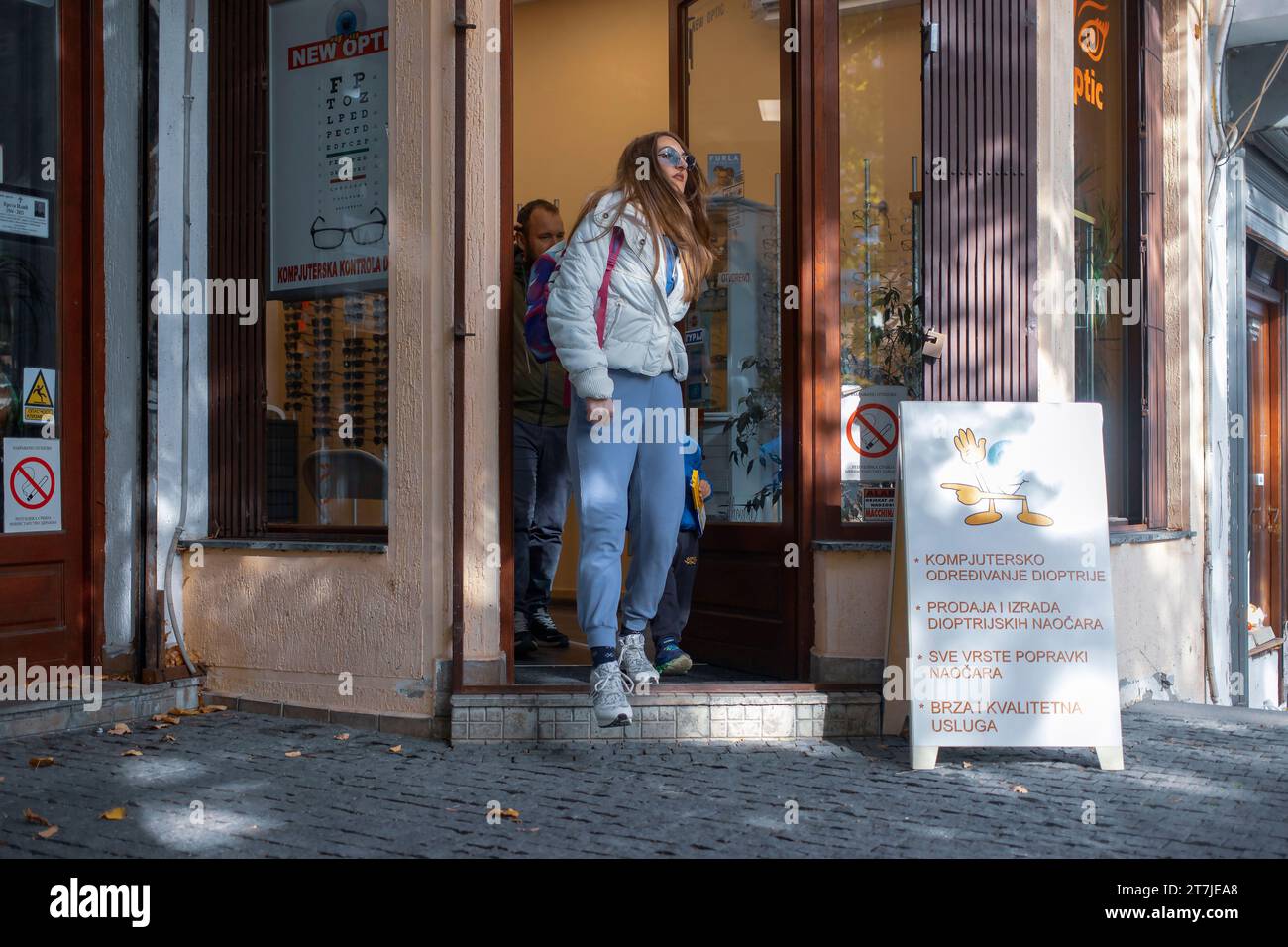 Belgrade, Serbie, 7 novembre 2023 : une jeune femme quitte le magasin d’optique Banque D'Images