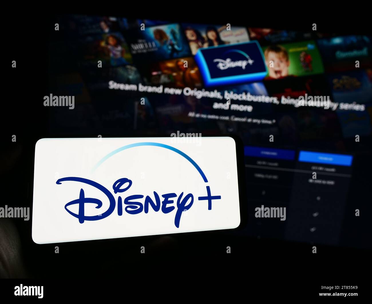 Personne détenant un téléphone mobile avec le logo du service américain de streaming vidéo à la demande Disney plus devant la page Web. Concentrez-vous sur l'affichage du téléphone. Banque D'Images