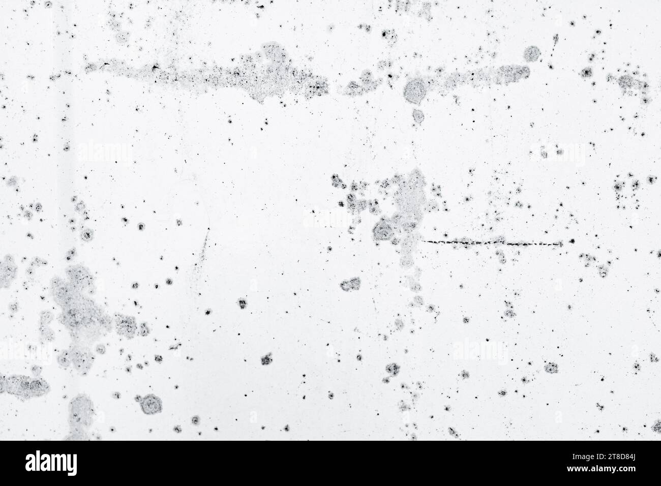Un mur texturé blanc et gris avec un motif de points noirs Banque D'Images