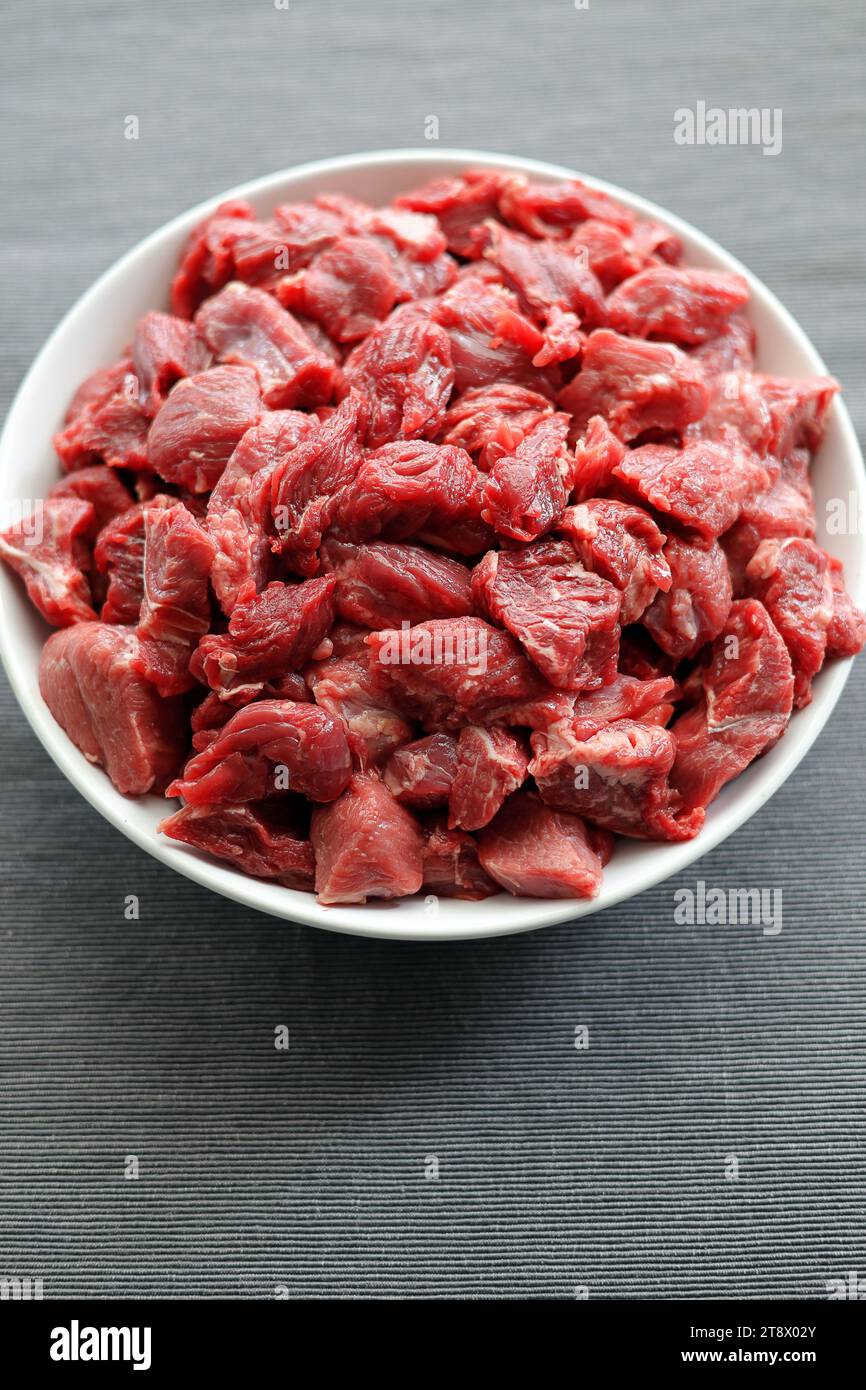 Bœuf frais, cru, coupé en morceaux, préparé pour le goulash et espace vide pour le texte Banque D'Images