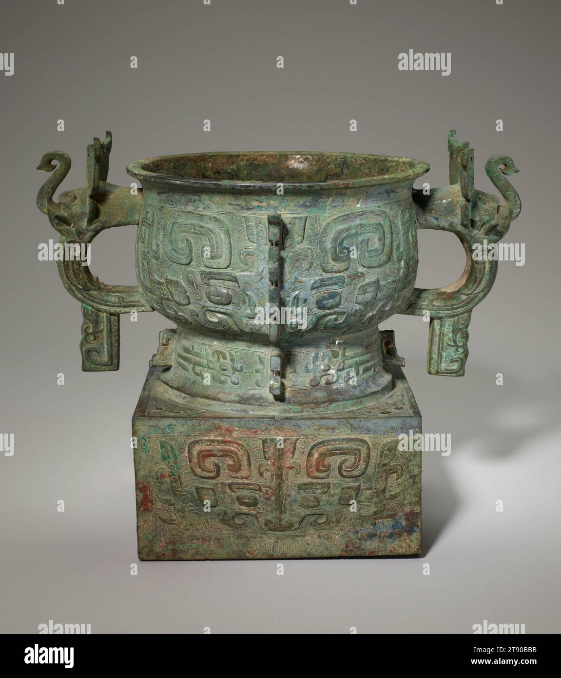 Récipient alimentaire GUI, 11e siècle av. J.-C., 11 5/16 × 13 3/4 × 9 1/16 po., 16,1 lb. (28,73 × 34,93 × 23,02 cm, 7,3 kg)7 5/8 × 7 1/2 po. (19,37 × 19,05 cm) (partie de l'objet, pied), Bronze, Chine, 11e siècle av. J.-C., cette interface graphique démontre l'inventivité avec laquelle les artisans Zhou occidentaux ont adapté les formes Shang. Le corps principal est une interface graphique standard avec un bol profond, tandis que les poignées en boucle de chaque côté du corps sont rendues de manière innovante sous la forme d’une tête et d’un tronc d’éléphant. En outre, le récipient est surélevé par une base carrée haute. Banque D'Images