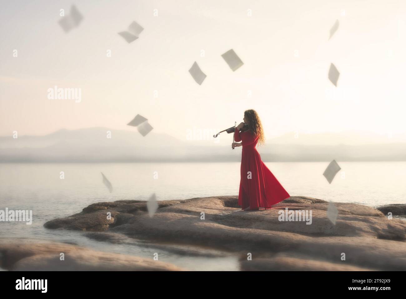 moment surréaliste de partition dansant dans le ciel dans le temps à la musique de violon d'une femme en jeu rouge Banque D'Images