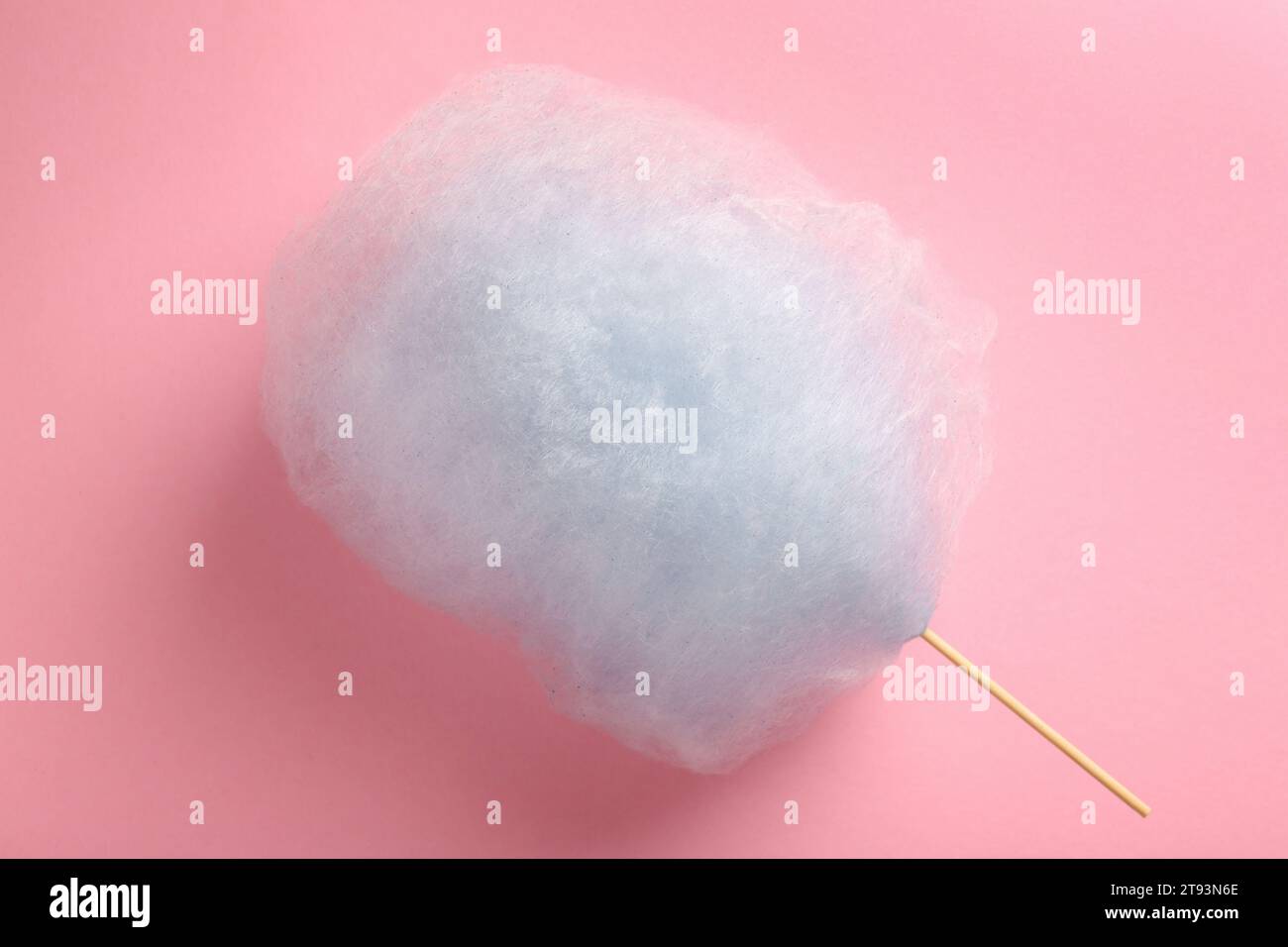Bonbons de coton bleu clair doux sur fond rose, vue de dessus Banque D'Images
