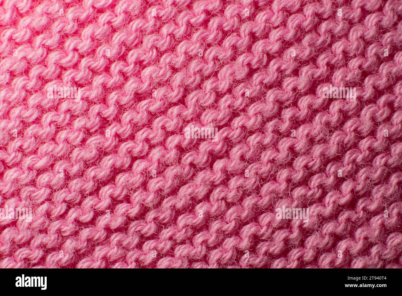Texture du tissu d'un pull rose. Banque D'Images