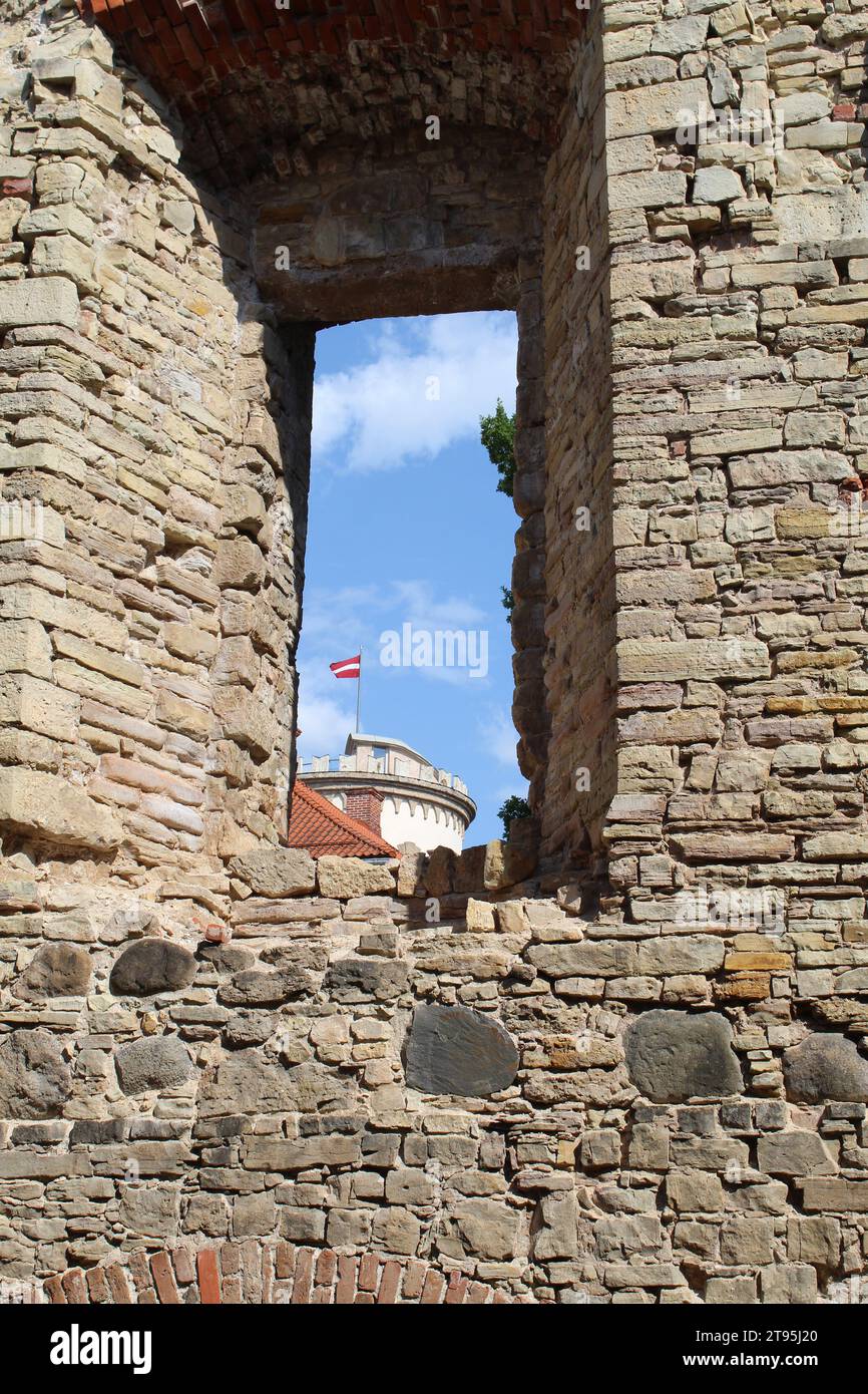 Drapeau letton visible à travers une fenêtre au château de Cesis en Lettonie Banque D'Images