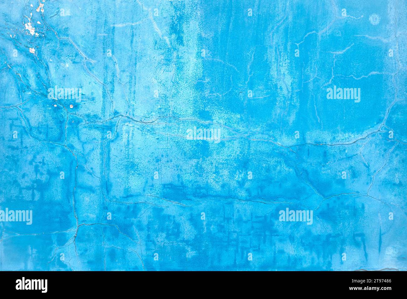 Mur avec peinture bleu clair brillant sur la surface, surface fissurée endommagée comme texture ou arrière-plan Banque D'Images