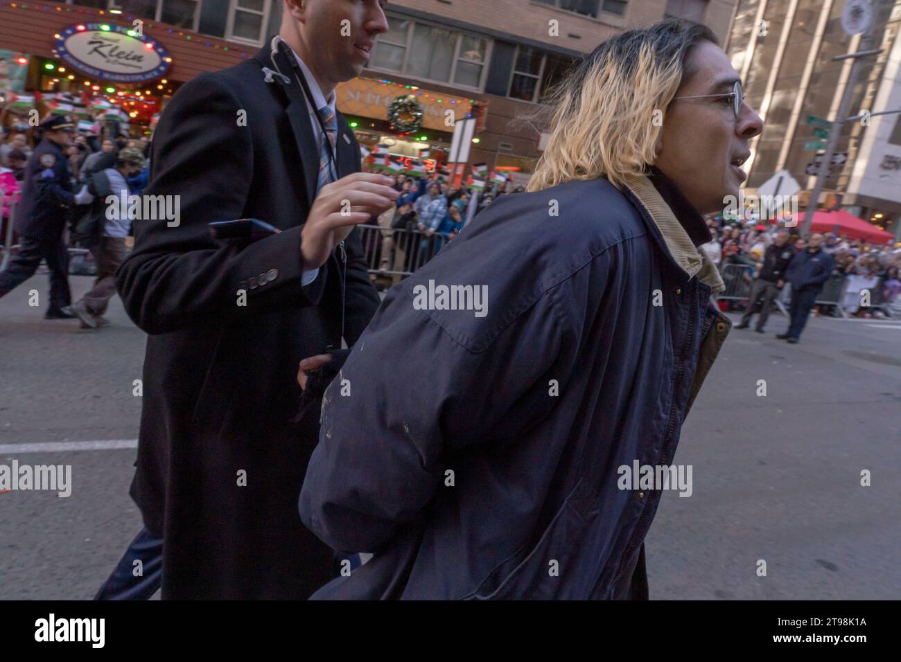 New York, États-Unis. 23 novembre 2023. NEW YORK, NEW YORK - NOVEMBRE 23 : un manifestant est arrêté alors que le défilé du jour de Thanksgiving de Macy était temporairement interrompu après qu'une poignée de manifestants pro-palestiniens ont sauté les barricades et se sont précipités dans la rue le long du parcours du défilé sur la Sixième Avenue le 23 novembre 2023 à New York. Crédit : Ron Adar/Alamy Live News Banque D'Images