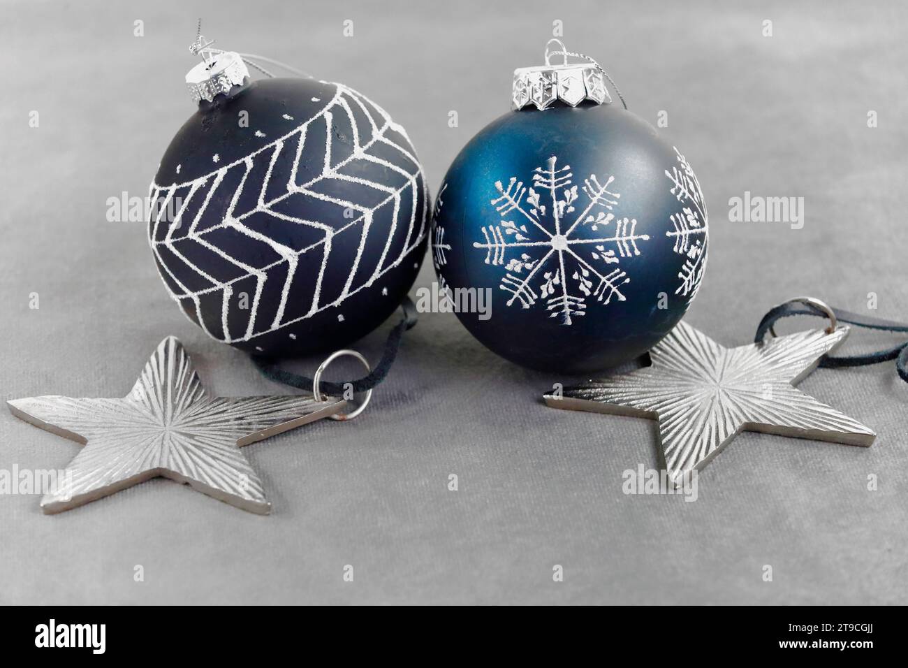 Deux boules sombres d'arbre de Noël et deux étoiles argentées pour la décoration Banque D'Images