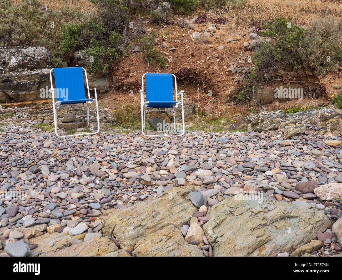Vieilles chaises longues sur une plage rocheuse en Australie méridionale. Banque D'Images