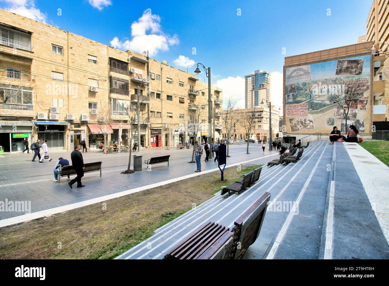 Les gens descendent la rue Jaffa et s’assoient sur les escaliers et les bancs du Centre Clal un jour de printemps à Jérusalem. Banque D'Images