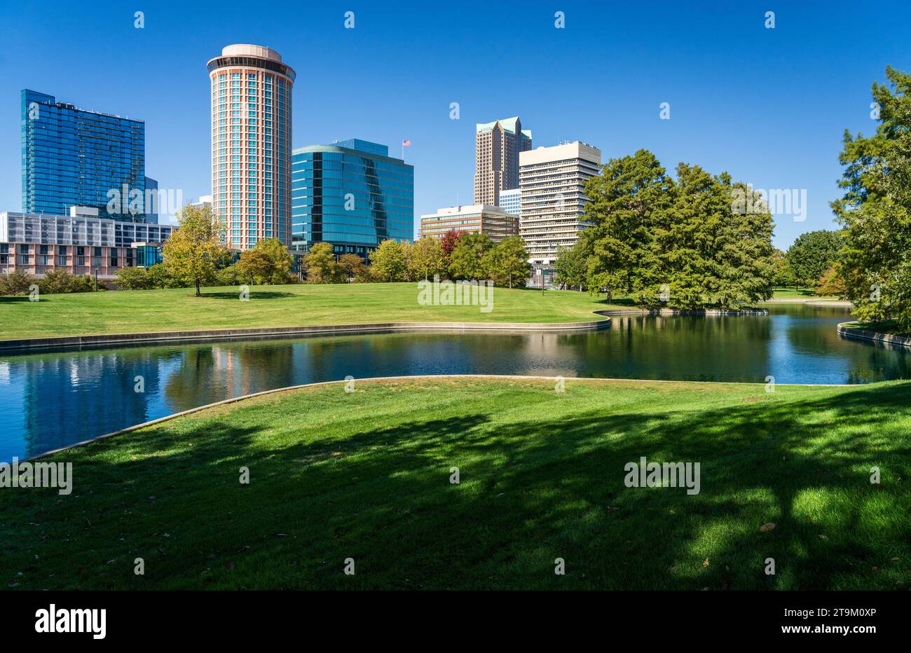 Vue à travers la plantation verte du parc Gateway Arch et à travers le lac pour les immeubles de bureaux et les hôtels du centre-ville de St Louis Missouri Banque D'Images