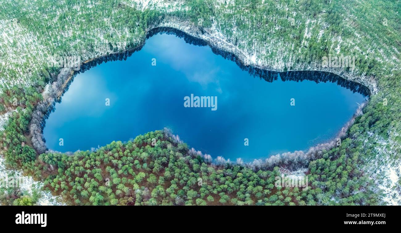 Vue aérienne du lac dans les forêts lituaniennes, nature hivernale sauvage. Nom du lac 'Meksrinis', district de Varena, Europe, parc national de Dzukija Banque D'Images