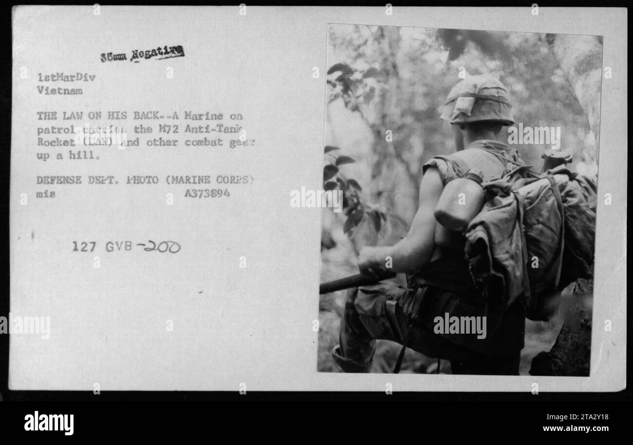 Un Marine stationné au Vietnam porte la fusée anti-char M72 (LAW) et d'autres équipements de combat sur son dos pendant sa patrouille. Cette photographie a capturé l'équipement utilisé par la 1stMarDiv (1st Marine Division) pendant la guerre du Vietnam. L'image montre les défis auxquels sont confrontés les militaires américains sur des terrains hostiles. Banque D'Images