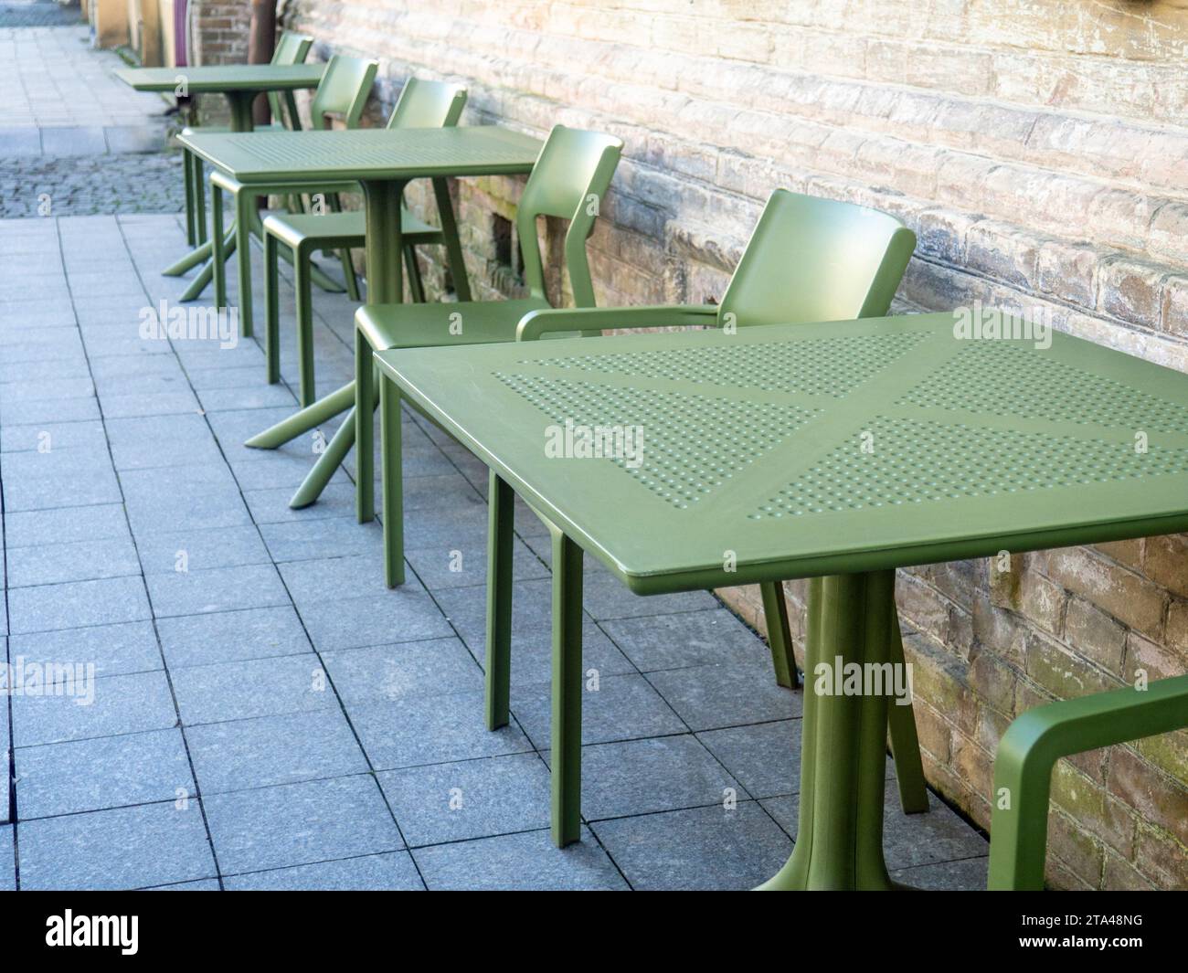 Des tables en plastique vides dans un café. Chaises vertes et tables à l'extérieur. Le concept d'absence de clients. Pas la saison pour les visiteurs. Banque D'Images