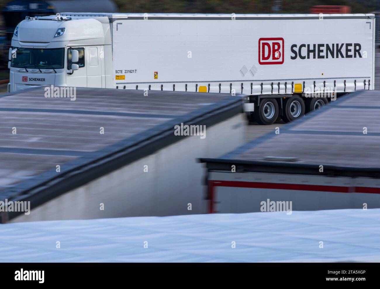 Rostock, Allemagne. 21 novembre 2023. Un camion de la société de logistique DB Schenker traverse le site du centre logistique dans le port maritime. La filiale logistique de Deutsche Bahn exploite plusieurs centres logistiques dans le Mecklembourg-Poméranie occidentale. Crédit : Jens Büttner/dpa/Alamy Live News Banque D'Images