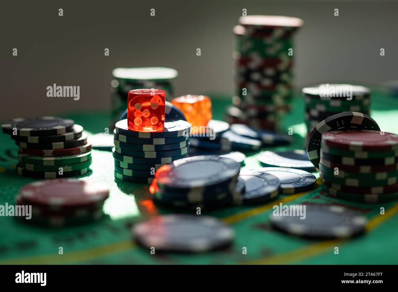 Des jetons de poker sur une table de jeux avec l'Éclairage dramatique Banque D'Images